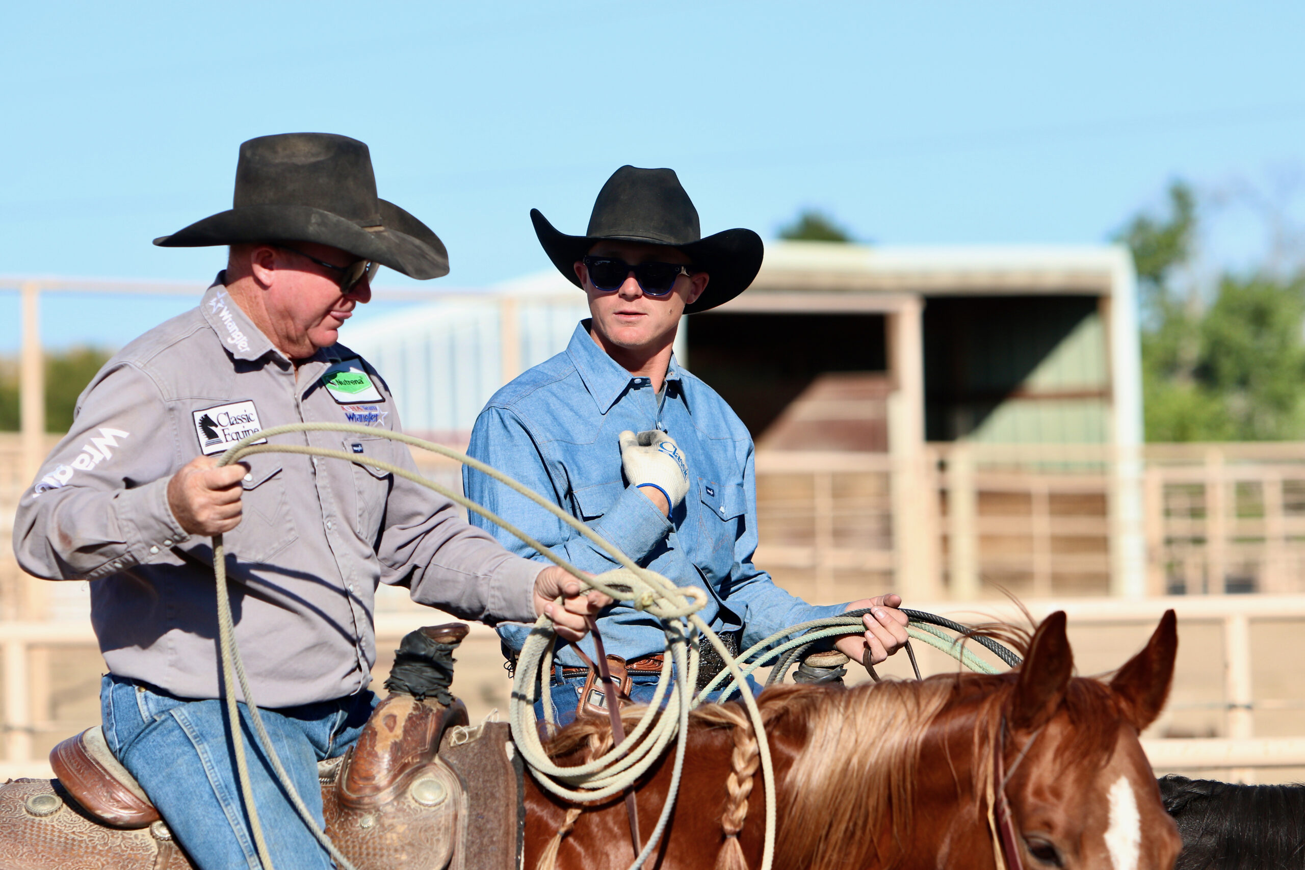 Two team ropers talking after a jackpot roping.